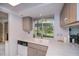 Efficient kitchen space featuring gray cabinets, modern appliances, and natural light from a window above the sink at 2113 Barksdale St, Port Charlotte, FL 33948