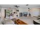 Inviting living room featuring a ceiling fan and a dining area nearby a sliding door at 2113 Barksdale St, Port Charlotte, FL 33948