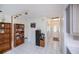Inviting living room with track lighting, white walls, and tiled floors leading to the front entrance at 2113 Barksdale St, Port Charlotte, FL 33948