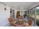 Enclosed patio featuring glass table and seating with views of the backyard at 2113 Barksdale St, Port Charlotte, FL 33948