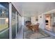 Enclosed patio featuring glass table and seating with views of the backyard and into the home at 2113 Barksdale St, Port Charlotte, FL 33948