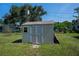 Outdoor shed with neutral tones, double door entry, and window offers useful backyard storage at 2113 Barksdale St, Port Charlotte, FL 33948