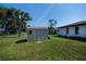 Outdoor shed with neutral tones, double door entry, and window offers useful backyard storage at 2113 Barksdale St, Port Charlotte, FL 33948
