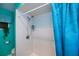 Bright shower with turquoise walls and a matching blue curtain, along with updated hardware at 2113 Barksdale St, Port Charlotte, FL 33948