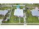 Aerial view of a home with a pool, surrounding greenery, and a well-maintained yard at 2321 Dallas St, Port Charlotte, FL 33952