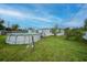 Spacious backyard featuring an above-ground pool and lush green grass at 2321 Dallas St, Port Charlotte, FL 33952