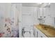 Bright bathroom with shower and tub featuring neutral decor and tile floors at 2321 Dallas St, Port Charlotte, FL 33952