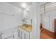 Compact bathroom with updated vanity, neutral paint and tiled floors at 2321 Dallas St, Port Charlotte, FL 33952