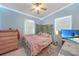 Cozy bedroom featuring a pink bedspread, accent lighting, and decorative wall vines at 2321 Dallas St, Port Charlotte, FL 33952