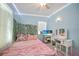 Bright bedroom with decorative wall vines, a pink bedspread and a vanity at 2321 Dallas St, Port Charlotte, FL 33952