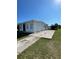 Charming single-story home featuring a concrete driveway and well-maintained landscaping with lush green grass at 2321 Dallas St, Port Charlotte, FL 33952
