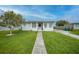 Charming single-story home with a well-manicured lawn and a quaint walkway leading to the entrance at 2321 Dallas St, Port Charlotte, FL 33952