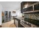 Modern kitchen equipped with stainless steel appliances and sleek black cabinetry at 2321 Dallas St, Port Charlotte, FL 33952