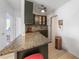 Open concept kitchen features stainless appliances, bar seating and neutral color palette at 2321 Dallas St, Port Charlotte, FL 33952