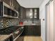 Well-organized kitchen featuring stainless steel appliances and dark wood cabinets at 2321 Dallas St, Port Charlotte, FL 33952