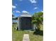 New shed with wide double doors and concrete paver path, adjacent to a nice lawn at 2321 Dallas St, Port Charlotte, FL 33952