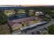 Aerial view of community featuring a lake, bridge, and well-maintained landscaping with buildings and parking at 23465 Harborview Rd # 1002, Punta Gorda, FL 33980
