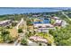A panoramic aerial shot capturing the building's lush surroundings, picturesque lake, and distant ocean views at 23465 Harborview Rd # 1002, Punta Gorda, FL 33980