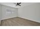 Clean and bright room with wood flooring and a modern ceiling fan at 23465 Harborview Rd # 1002, Punta Gorda, FL 33980