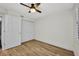 Bedroom features a closet, ceiling fan, and light wood flooring at 23465 Harborview Rd # 1002, Punta Gorda, FL 33980