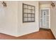 Welcoming front entrance with a window, screen door, bronze sconce lights, and brick tile flooring at 23465 Harborview Rd # 1002, Punta Gorda, FL 33980