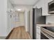 Bright kitchen with stainless steel appliances, white cabinets, and tile flooring at 23465 Harborview Rd # 1002, Punta Gorda, FL 33980