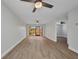 Living room with hardwood floors, neutral paint and sliding glass doors to the lanai overlooking the water at 23465 Harborview Rd # 1002, Punta Gorda, FL 33980