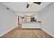 Living room with hardwood floors open to the kitchen with bar seating and neutral paint at 23465 Harborview Rd # 1002, Punta Gorda, FL 33980
