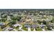 A high angle aerial shows houses with pools in a developed suburban neighborhood with tree lined streets at 25273 Paraguay St, Punta Gorda, FL 33983