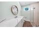 Modern bathroom features marble counters, wood floors, walk-in shower, and eye-catching stained glass at 25273 Paraguay St, Punta Gorda, FL 33983