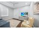 Bedroom with wood floors, ceiling fan, and a TV featuring a beach scene at 25273 Paraguay St, Punta Gorda, FL 33983