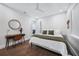 Clean bedroom featuring a ceiling fan, minimalist decor, and wood look floors at 25273 Paraguay St, Punta Gorda, FL 33983