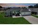 Lovely single-story home featuring a manicured lawn, two-car garage, and an inviting entrance at 25273 Paraguay St, Punta Gorda, FL 33983