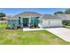 Beautifully landscaped single Gathering home with a well manicured lawn and a two-car garage at 25273 Paraguay St, Punta Gorda, FL 33983