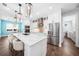 Bright kitchen with a large marble countertop island, stainless steel appliances, and modern lighting at 25273 Paraguay St, Punta Gorda, FL 33983