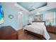 Bright main bedroom featuring a tray ceiling, ambient lighting, and stylish furniture at 25273 Paraguay St, Punta Gorda, FL 33983
