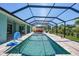 Screened-in pool with lounge furniture and lush landscaping at 25273 Paraguay St, Punta Gorda, FL 33983