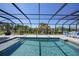 Relaxing screened-in pool area with lounge chairs and mature landscaping at 25273 Paraguay St, Punta Gorda, FL 33983