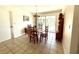 Dining area with traditional table and chairs, next to sliding glass doors with pool view at 261 Caddy Rd, Rotonda West, FL 33947