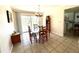 Dining room with wood table and chairs, chandelier, and sliding glass doors overlooking the pool at 261 Caddy Rd, Rotonda West, FL 33947