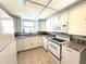 Bright kitchen featuring white cabinets, granite countertops, and a modern range at 261 Caddy Rd, Rotonda West, FL 33947