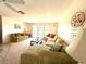 Comfortable living room featuring green sofa, carpet, and decor at 261 Caddy Rd, Rotonda West, FL 33947
