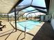 Beautiful screened-in pool with clear blue water, offering a serene outdoor retreat at 261 Caddy Rd, Rotonda West, FL 33947