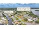 An aerial view features a waterfront home close to Harbour Heights Park with tennis and shuffleboard courts at 27385 Voyageur Dr, Punta Gorda, FL 33983