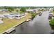 Waterfront home featuring solar panels and private dock along a canal leading to open water at 27385 Voyageur Dr, Punta Gorda, FL 33983