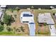 Aerial view of the home with solar panels, manicured lawn, and canal in the backyard at 27385 Voyageur Dr, Punta Gorda, FL 33983