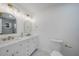 Bright bathroom with dual sinks, modern lighting, and quartz countertops at 27385 Voyageur Dr, Punta Gorda, FL 33983