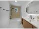 Modern bathroom with a white vanity, a shower/tub combination and black hardware at 27385 Voyageur Dr, Punta Gorda, FL 33983