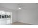 Bright bedroom with neutral walls, tile floors, and ceiling fan with light at 27385 Voyageur Dr, Punta Gorda, FL 33983
