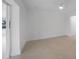 Bright bedroom with neutral walls, tile floors, and ceiling fan with light at 27385 Voyageur Dr, Punta Gorda, FL 33983